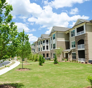 Modern apartment complex with balconies and lawn