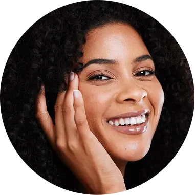 Close-up of smiling woman with curly hair