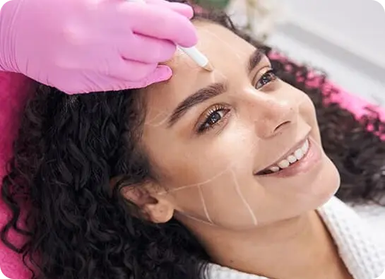 Woman smiling during facial cosmetic procedure